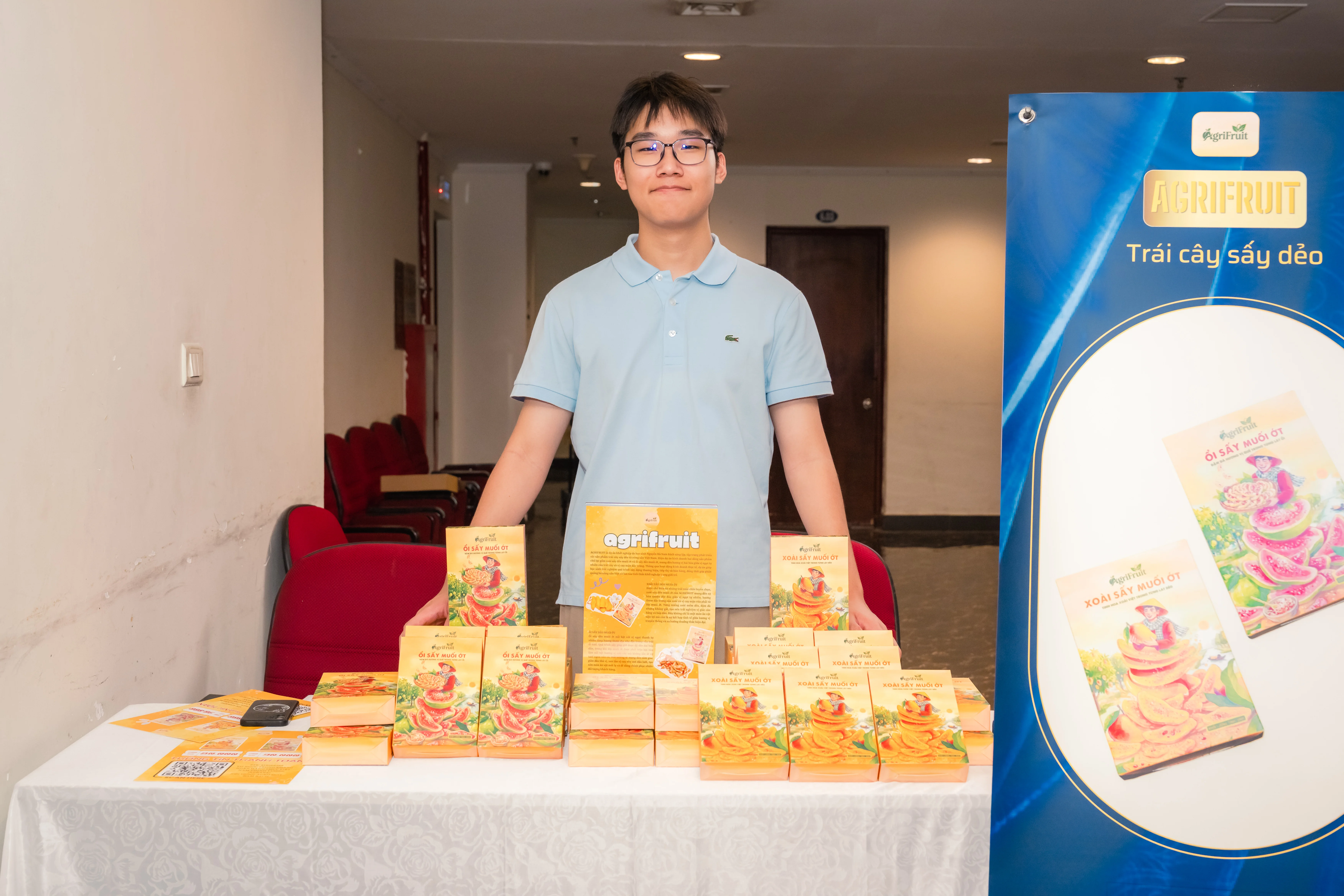 AgriFruit founder standing with dried fruit products at a display booth